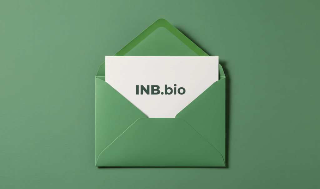 A green envelope partially open, revealing a white card that prominently displays the text "INB.bio." The background is a solid green.