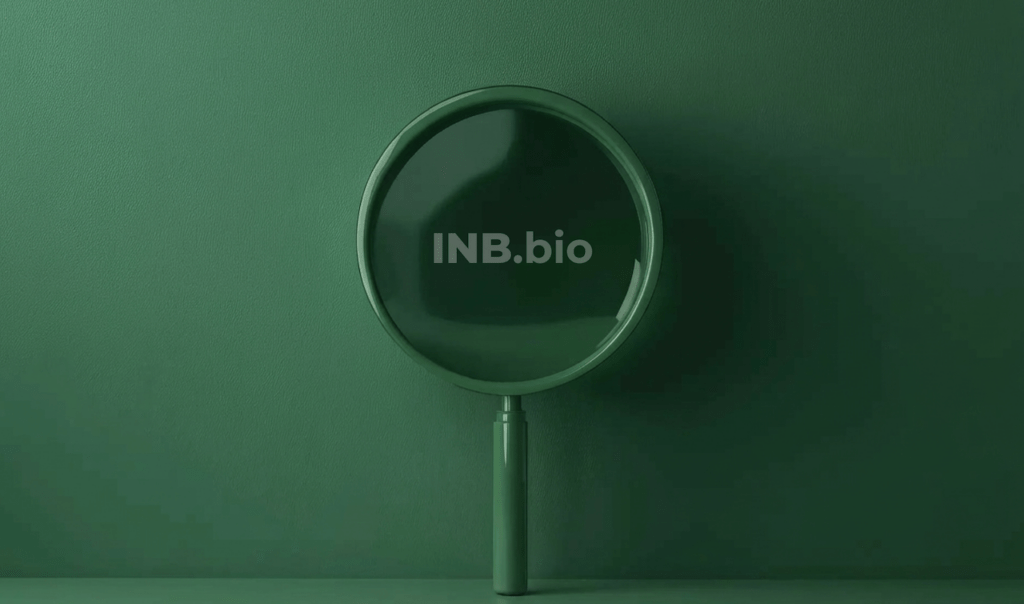 A green magnifying glass set against a matching green background, featuring the text "INB.bio" in the center.