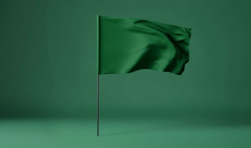 A green flag gently waving on a thin pole, set against a matching green background, creating a unified color theme.