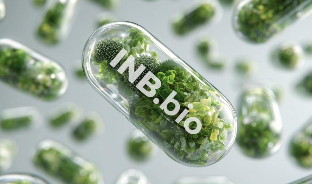 Transparent capsules filled with green plants and labeled "INB.bio" floating against a light background.