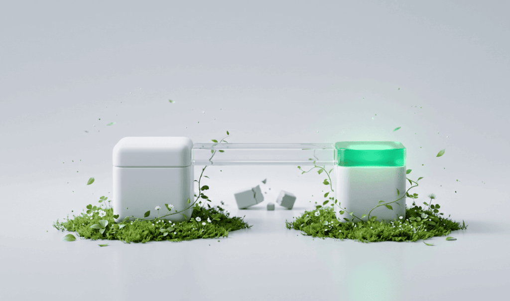 Two white cube devices connected by a transparent tube, surrounded by green moss and small plants on a white background.