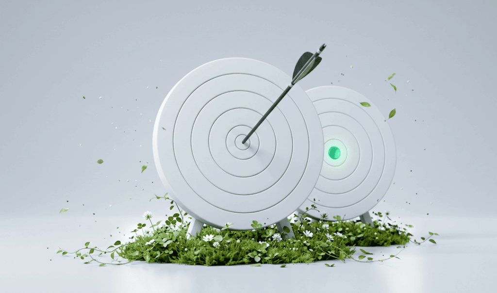 Two white archery targets on grass, one with an arrow in the bullseye, the other glowing green in the center.