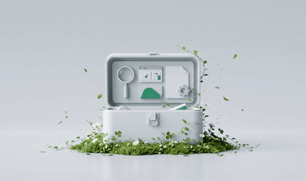 White open toolbox with digital icons inside, surrounded by green plants on a light gray background.